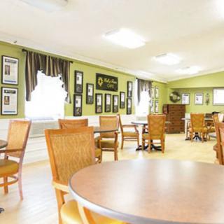A bright and spacious dining area with neatly arranged tables and chairs.