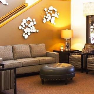 A cozy living room with a modern sofa, armchairs, and stylish decor.