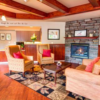 A cozy living room with a warm fireplace, comfortable seating, and stylish decor.