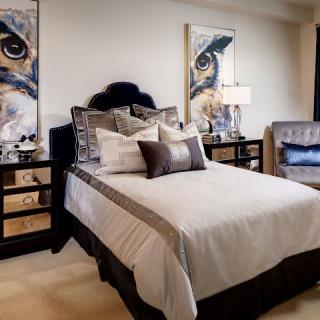 A modern bedroom with stylish decor and artwork.