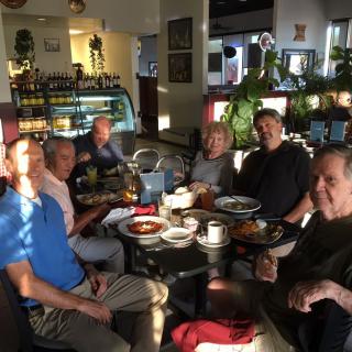 A group of people enjoying a meal together at a cafe.