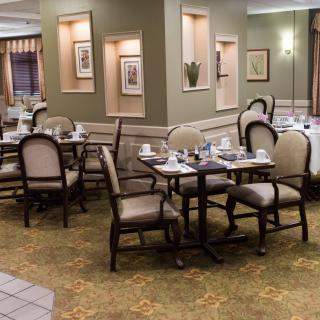 An empty dining area with neatly arranged tables and chairs.