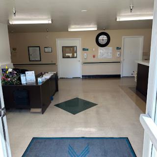 A welcoming interior view of a healthcare office's waiting area and reception.