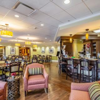A cozy restaurant interior featuring a bar and comfortable seating areas.