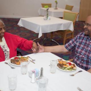 Two people enjoying a meal together in a dining setting.