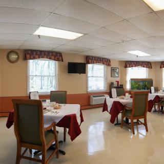 A spacious dining area with neatly arranged tables and chairs, designed for communal meals.