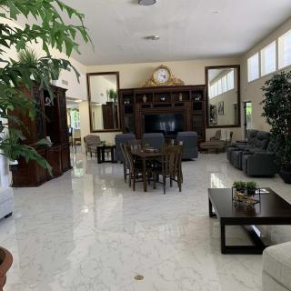A spacious and well-decorated living room with comfortable seating and a large television.