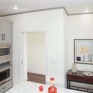 A modern kitchen interior featuring built-in appliances and stylish decor.