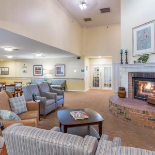 A cozy living room with comfortable seating and a warm fireplace.