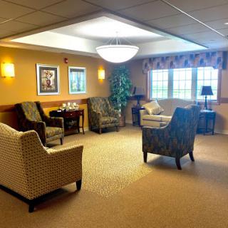 A cozy lounge area featuring comfortable seating and warm lighting.