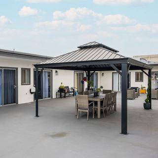 A spacious patio with a gazebo and outdoor dining set.