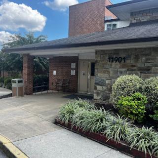 A welcoming entrance to a healthcare facility with well-maintained landscaping.
