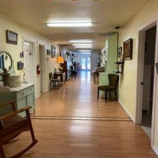 A well-decorated hallway with furniture and decorations along the walls.