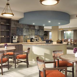 A modernly decorated cafe interior with tables and chairs.
