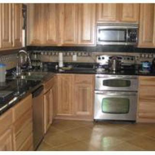 A modern kitchen with stainless steel appliances and wooden cabinets.