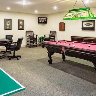 A cozy game room featuring a billiards table and a poker table, perfect for indoor recreation.