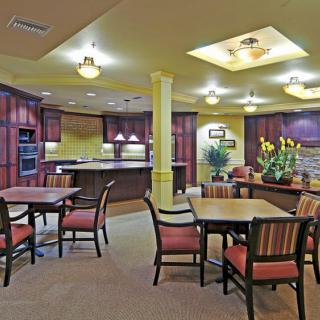 A cozy communal kitchen and dining area with warm lighting and comfortable seating.