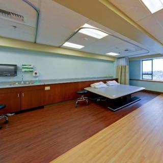 A modern hospital room with a patient bed and medical equipment.