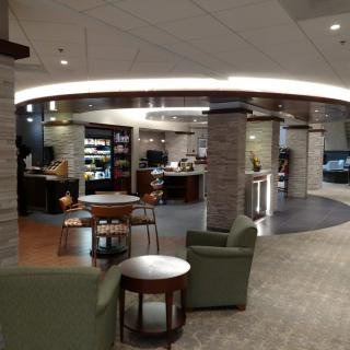 A cozy indoor lounge with seating and a coffee shop.