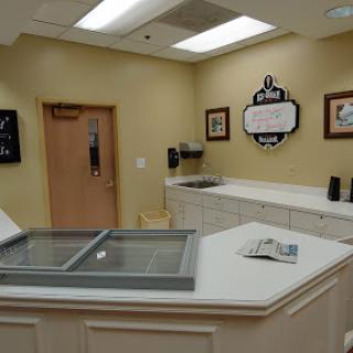 A well-lit service area featuring a counter and wall decor, suggesting a welcoming environment.