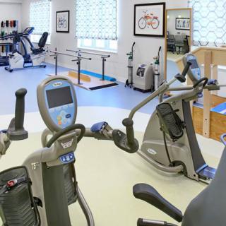 A well-equipped rehabilitation and therapy room with various exercise machines.