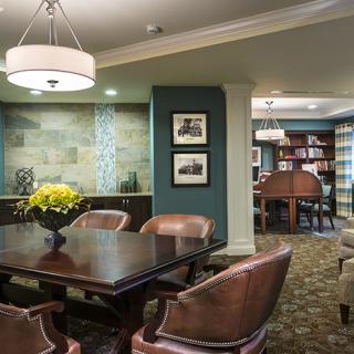 A modern interior space featuring a dining or conference area with elegant furniture and decor.