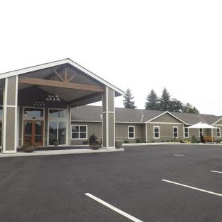 A commercial building with an entrance and empty parking lot.