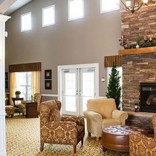 A cozy living room with comfortable seating and a stone fireplace.