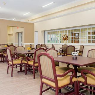 A spacious dining area with multiple tables and chairs arranged neatly.