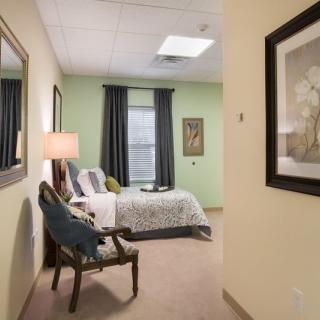 A cozy bedroom with modern decor and soft lighting.