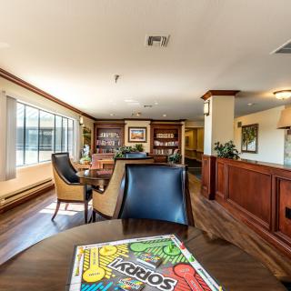 A modern office lobby with comfortable seating and large windows.