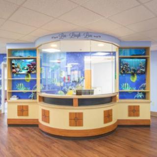 A vibrant and welcoming hospital reception desk designed for a children's area.