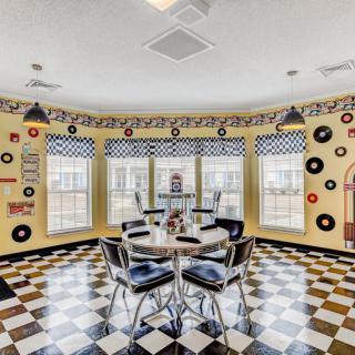 A retro diner-style room with checkered flooring, classic decor, and a nostalgic atmosphere.