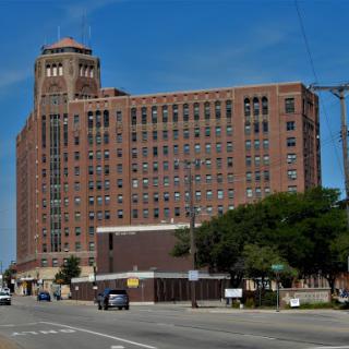 A historic brick building showcasing classic architectural design in an urban setting.