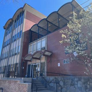 A modern multi-story office building with distinct architectural features.