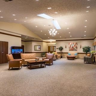 A spacious and elegantly designed lobby with comfortable seating and a stylish chandelier.