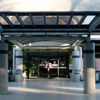 A modern building entrance with glass panels and columns.