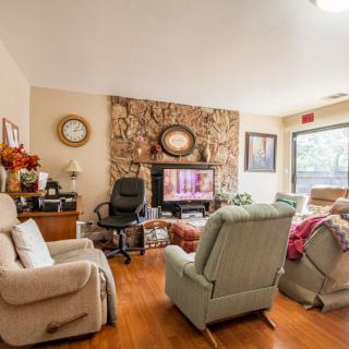 A cozy living room with recliners, a television, and decorative elements.