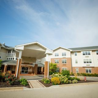 A modern residential building with a landscaped entrance.