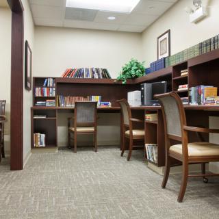A quiet study room with bookshelves and seating areas.