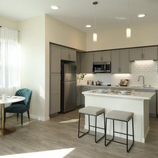 A modern kitchen with a dining area and sleek interior design.