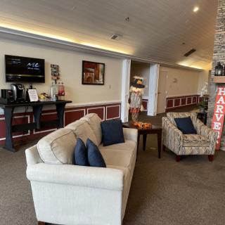 A cozy lobby area with comfortable seating and a television.