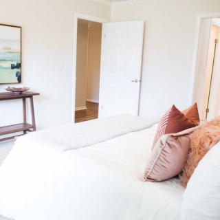 A cozy bedroom with soft pillows and a minimalist design.