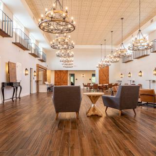 Spacious lobby with elegant chandeliers and comfortable seating.