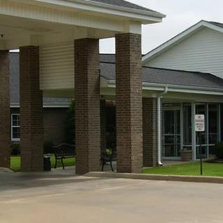 Entrance of a brick commercial building with a driveway.