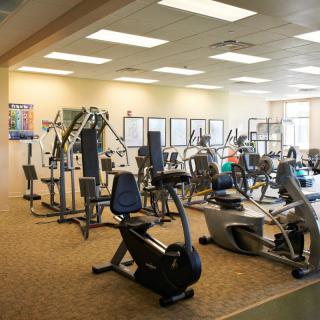 A spacious gym featuring various exercise machines and workout equipment.