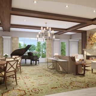 A luxurious living room featuring a grand piano, elegant chandelier, and cozy seating area by the fireplace.