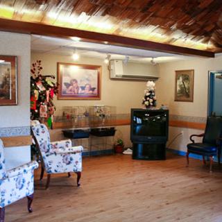 A cozy lounge area featuring decorative chairs and artwork, perfect for relaxation.