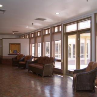 A spacious lobby area with comfortable seating and large windows.
