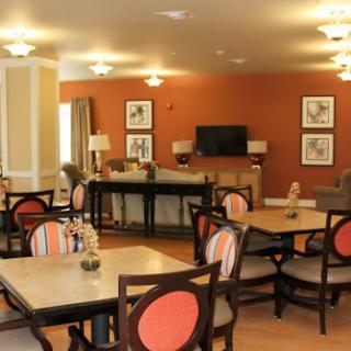 A cozy dining area with modern furniture and a warm color palette.
